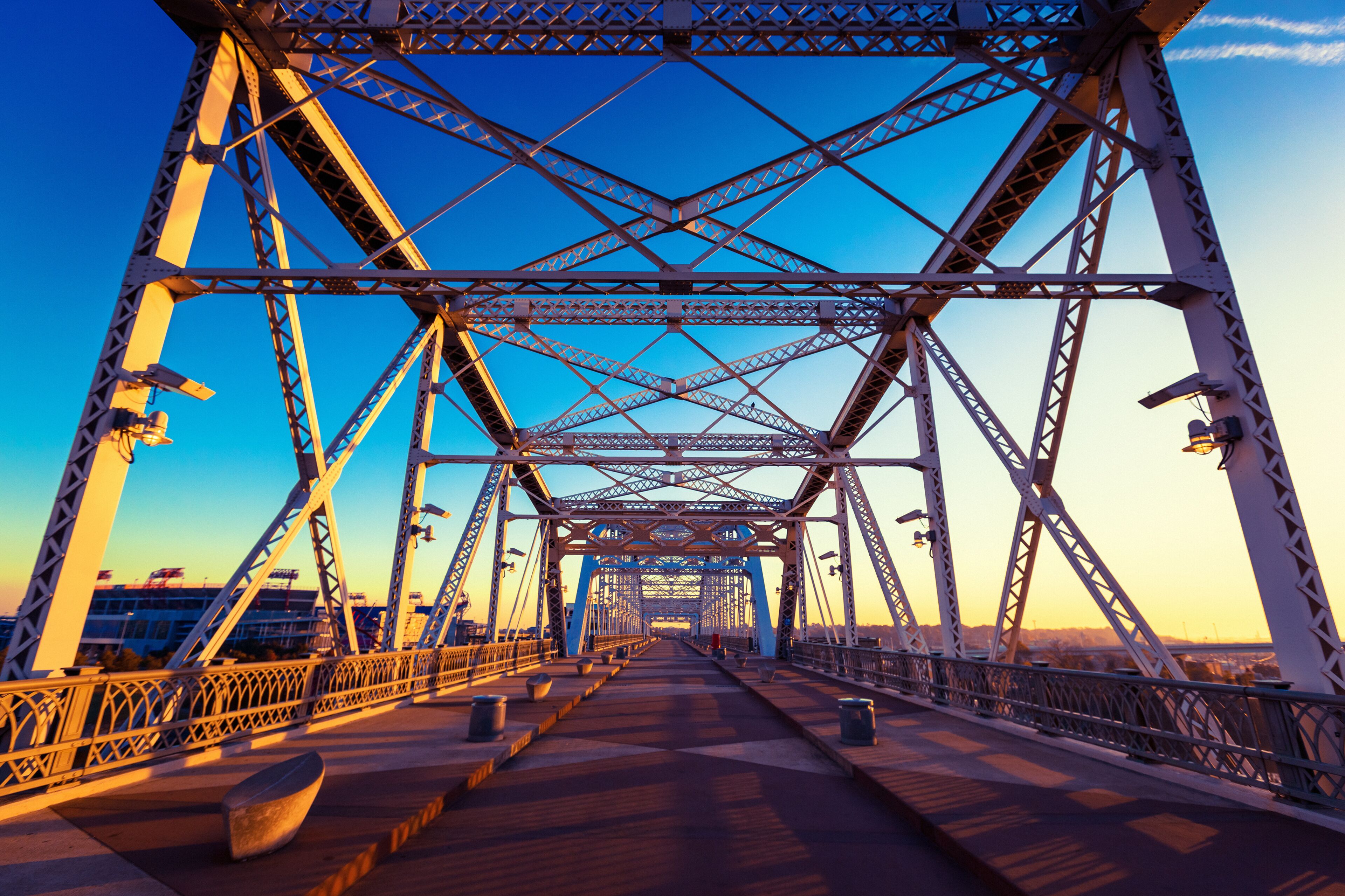 A steel bridge with a clear sky at sunset.
