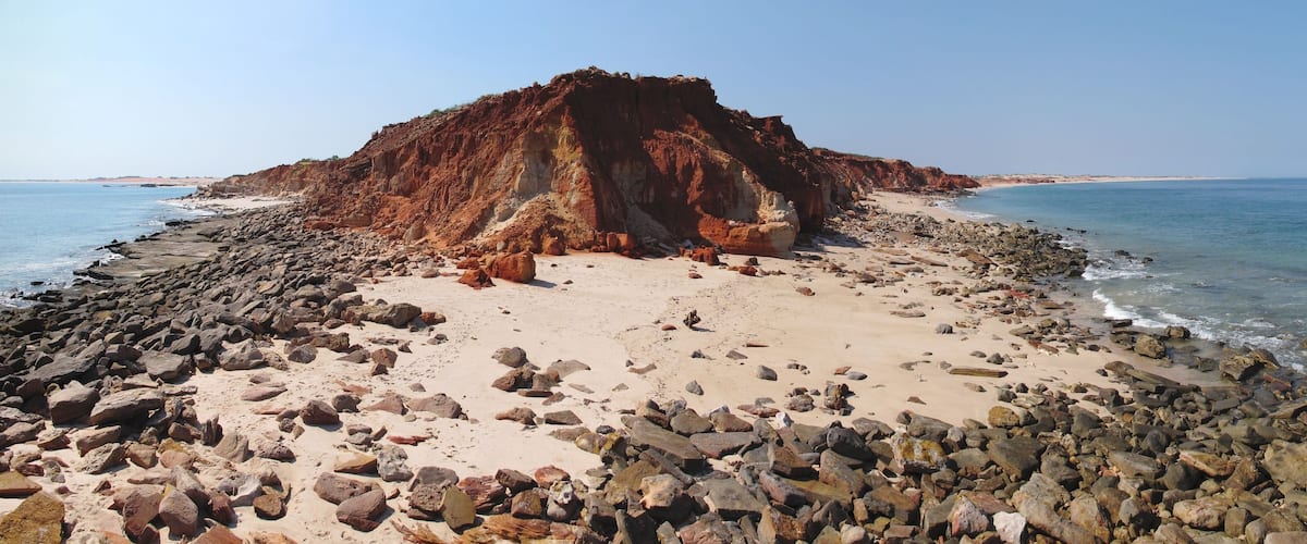 A rocky beach with a prominent cliff formation.