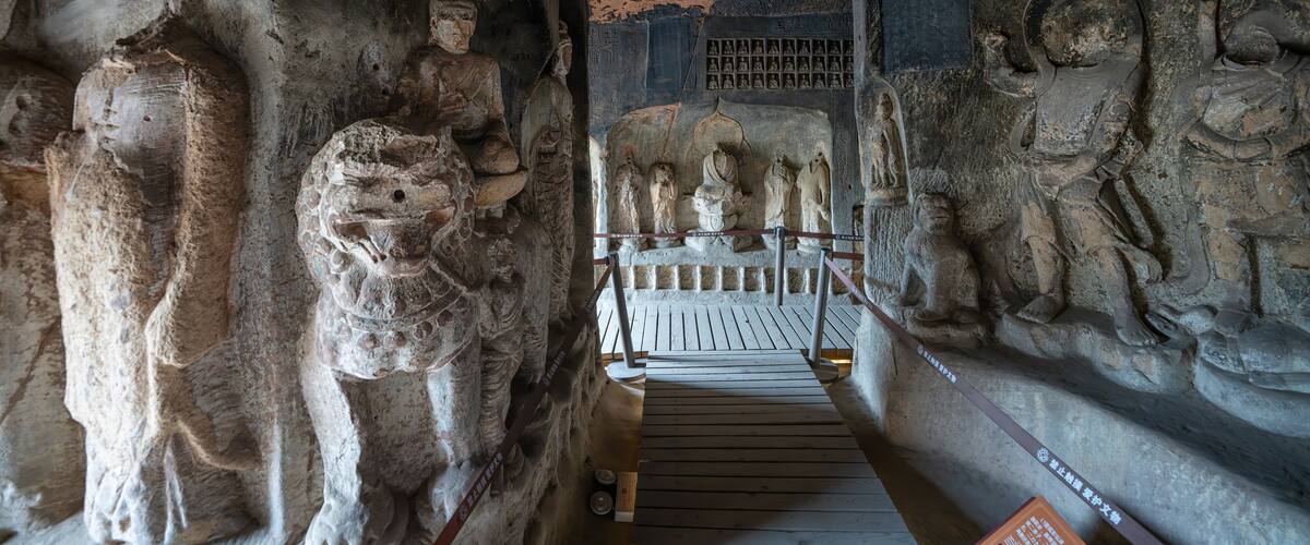 A cave with ancient carvings and statues.