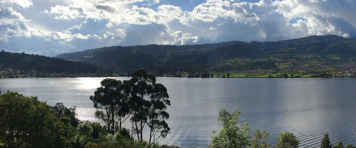 A lake surrounded by mountains and a town.