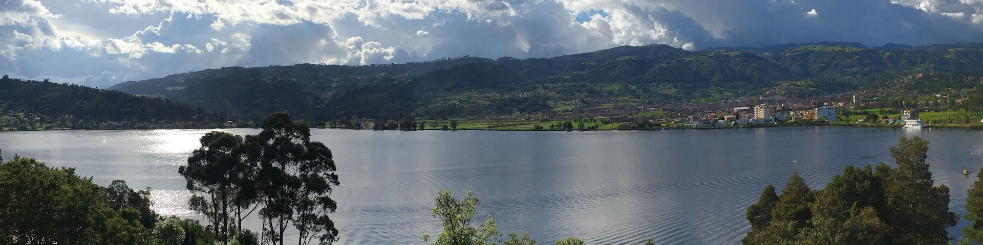 A lake surrounded by mountains and a town.