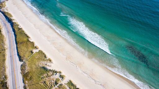 Beach Road and Ocean on a Sandy Beach Shoreline from Aerial Drone