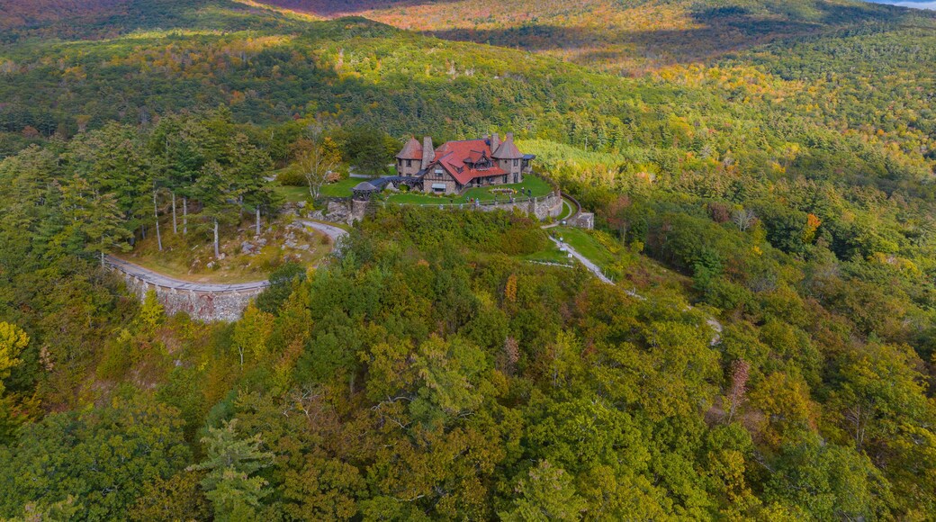 Castle in the Clouds aka Lucknow mansion aerial view in fall at the top of Lee Mountain with Lake Winnipesaukee and Ossipee Mountains at the background in town of Moultonborough, New Hampshire NH, USA