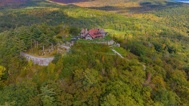 Castle in the Clouds aka Lucknow mansion aerial view in fall at the top of Lee Mountain with Lake Winnipesaukee and Ossipee Mountains at the background in town of Moultonborough, New Hampshire NH, USA
