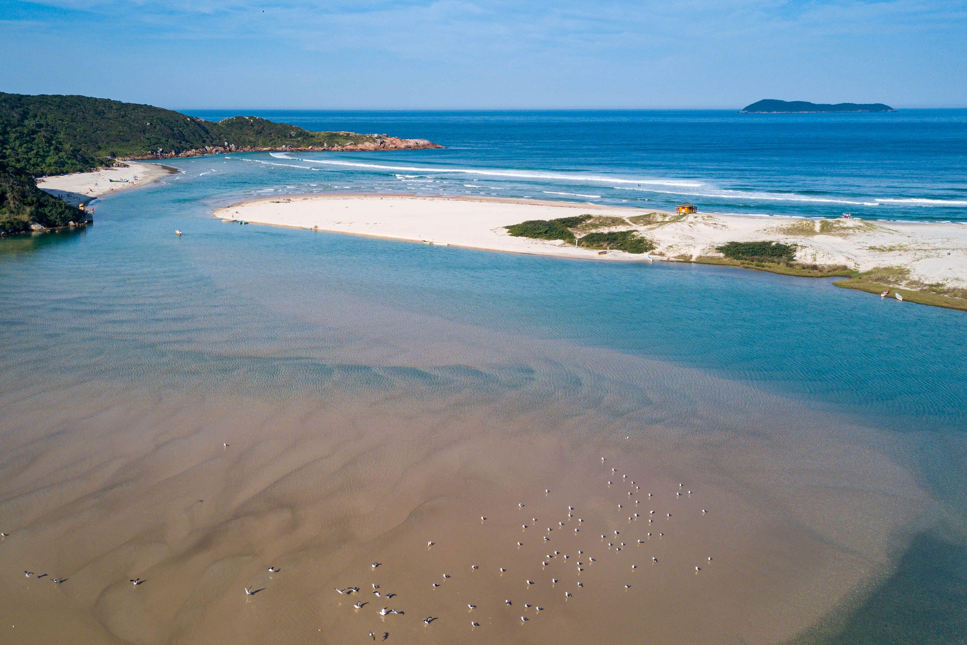 Sandy beach surrounded by hills and river (Guarda do Embau, Imbituba, Brazil); Shutterstock ID 1440260222; Purchase Order: -