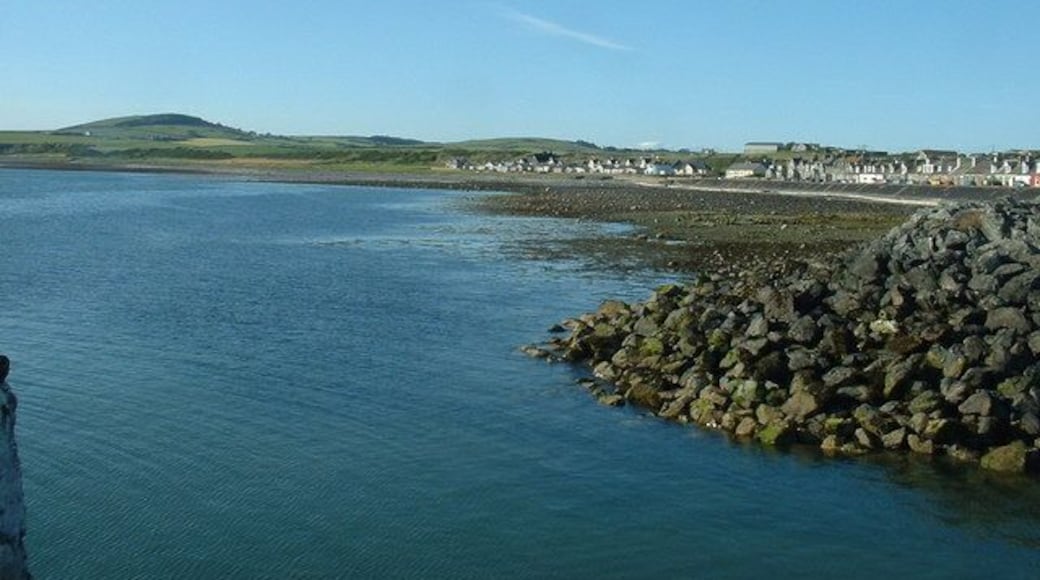 Harbour entrance, Port William. Looking north, up the coast. The linear extension of Port William is clearly seen. More housing development is planned at the far end of the line of houses.