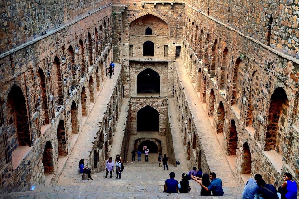 An ancient stone structure with multiple arches and a central passageway.