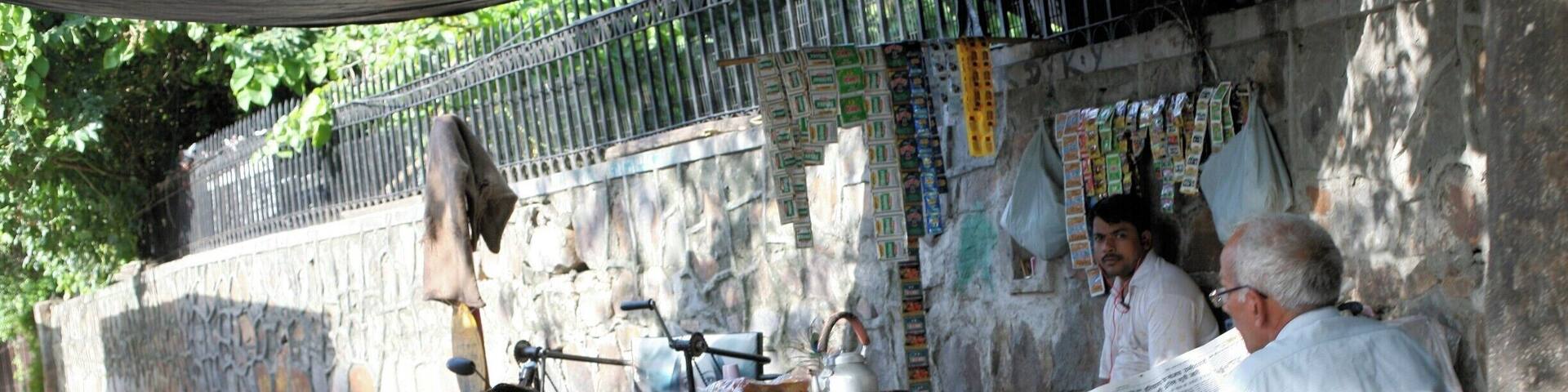 People seem to live out their lives in the streets of New Delhi. Here they gather to read the newspapers.