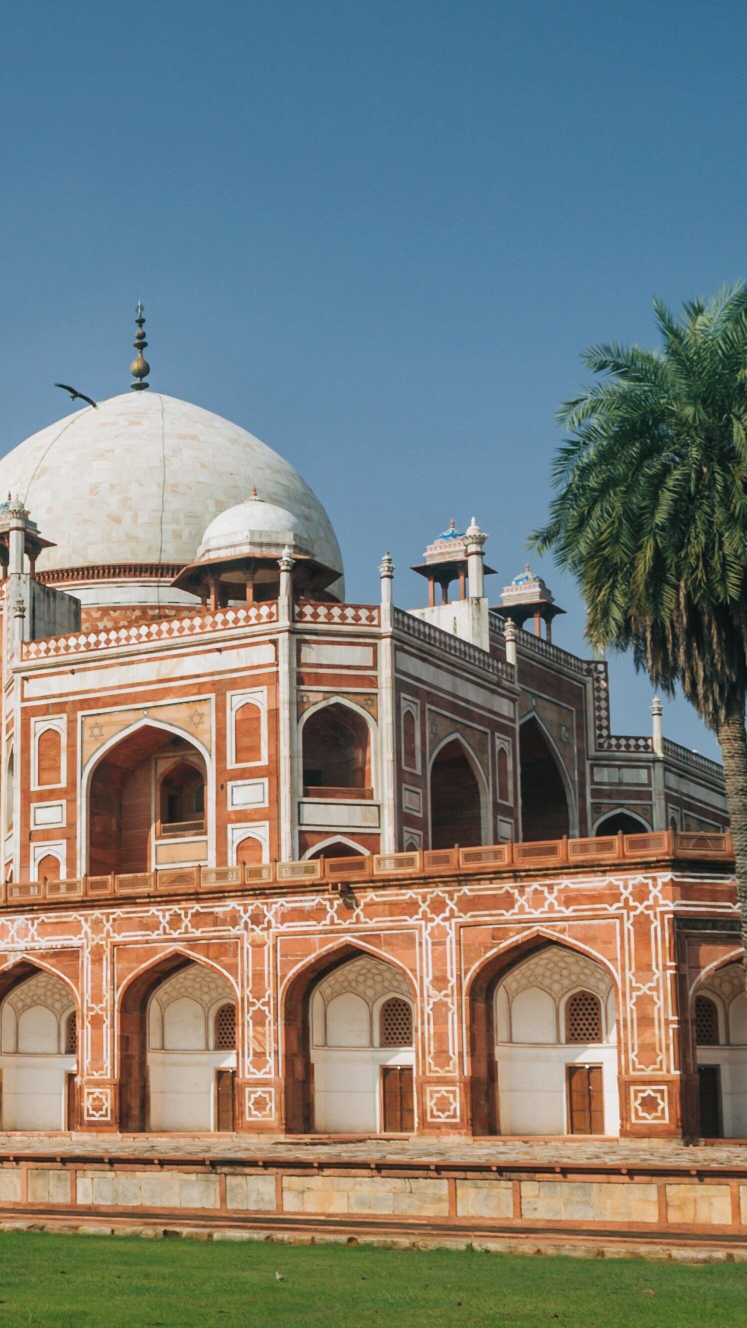 Explore the architectural beauty of Humayun's Tomb in Defence Colony, New Delhi, showcasing intricate Mughal designs and lush greenery under a clear blue sky