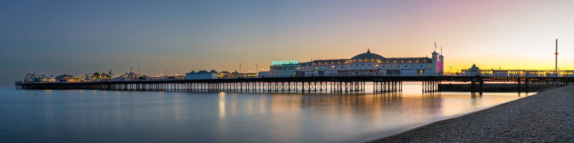 Panoramic view of the Brighton Pier at sunset. England