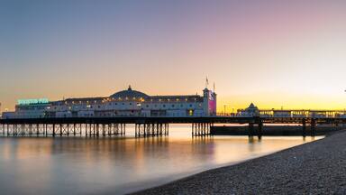 Panoramic view of the Brighton Pier at sunset. England