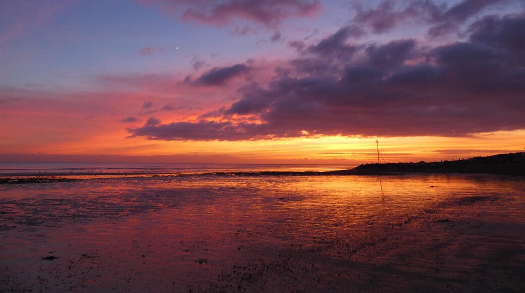 On the south coast, this beach lined by white beach huts gets great sunsets. #perspective