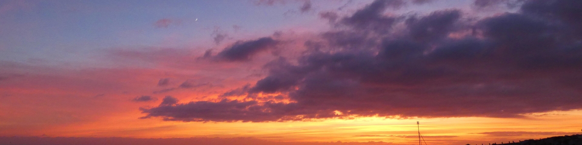 On the south coast, this beach lined by white beach huts gets great sunsets. #perspective