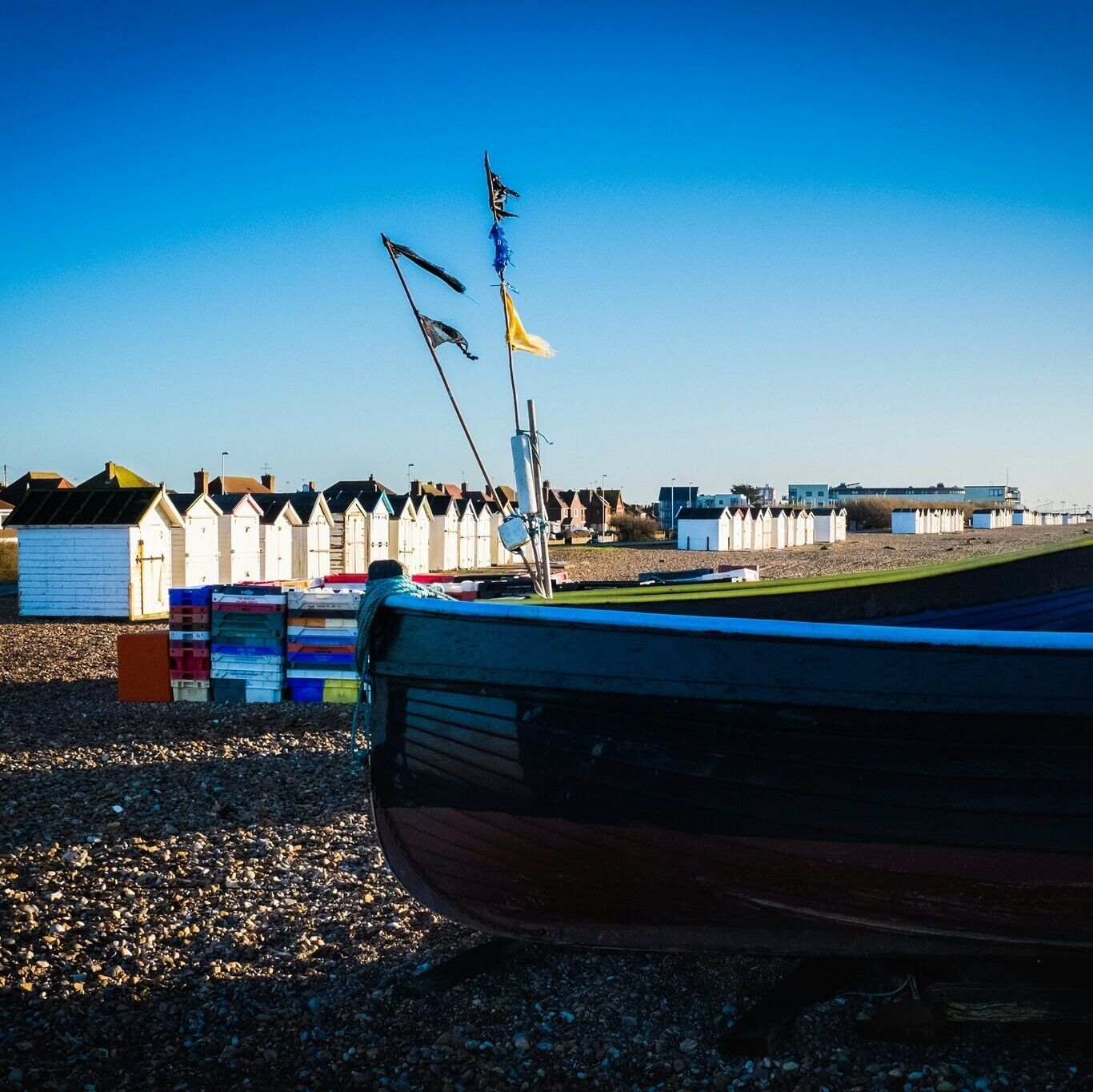 Fishing boat and beach huts on the Sussex Coast