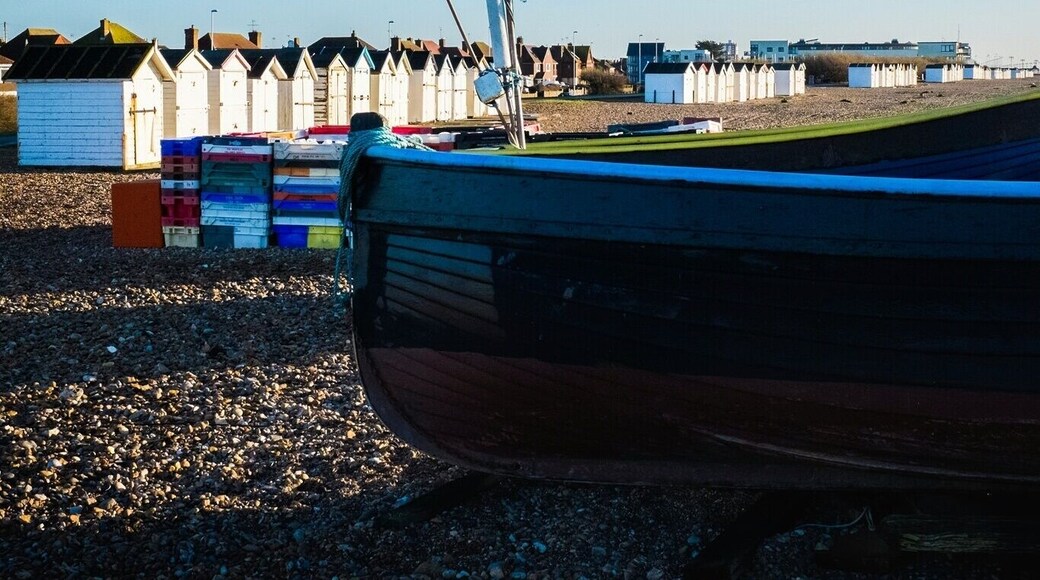 Fishing boat and beach huts on the Sussex Coast