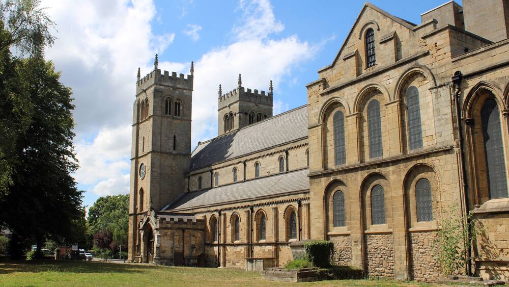 A historic church with a prominent tower and arched windows.