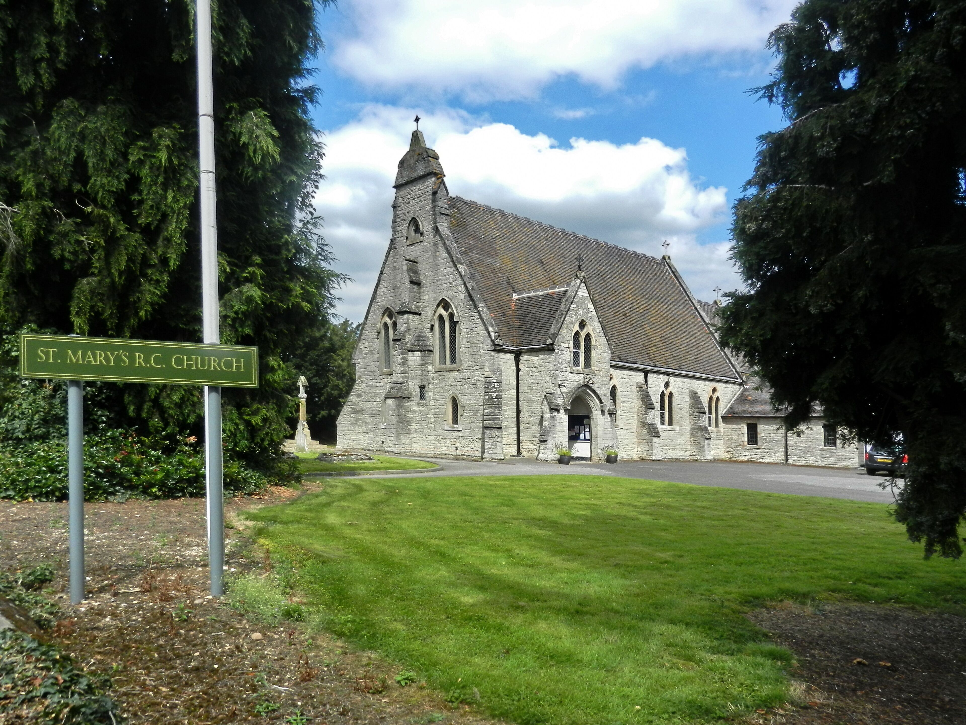 St. Mary's R.C. Church with a stone facade and a pointed steeple.