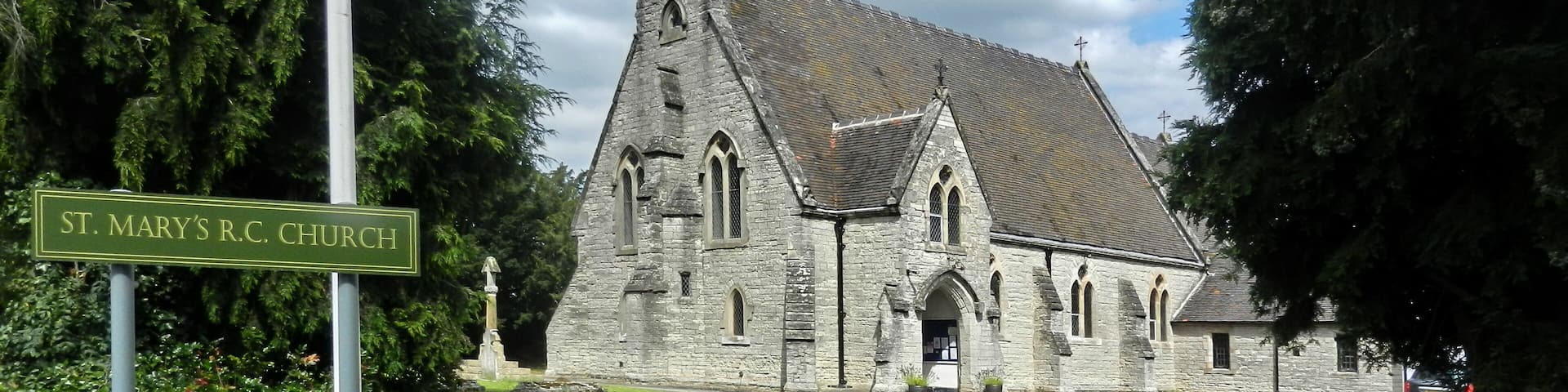 St. Mary's R.C. Church with a stone facade and a pointed steeple.
