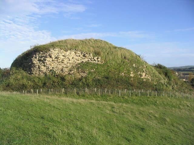 The keep at Wark Castle This large keep on the motte of Wark Castle is now mostly rubble, barely defining the line of the keep walls below a blanket of scrub. The castle dates back to the early 12th century. (Source: Borders and Berwick, An Architectural Guide by Charles Alexander Strang)