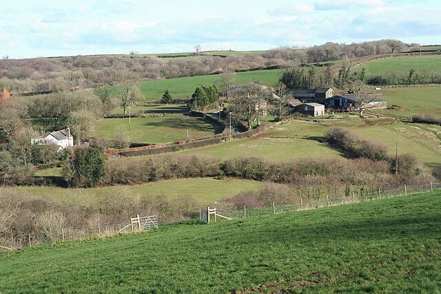 Meshaw: towards Parsonage Farm Parsonage Farm is centre right in this view, with Prescott on the left, by the lane from Meshaw to East Whitestone. Looking east-north-east by the A373 road