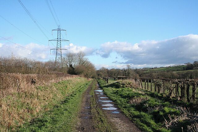 Bishops Nympton: course of the Taunton-Barnstaple railway This branch opened as a broad gauge line in November 1873 and was converted to standard gauge in May 1881. It closed in 1965. Here it is paralleled by a National Grid overhead transmission line. Looking east