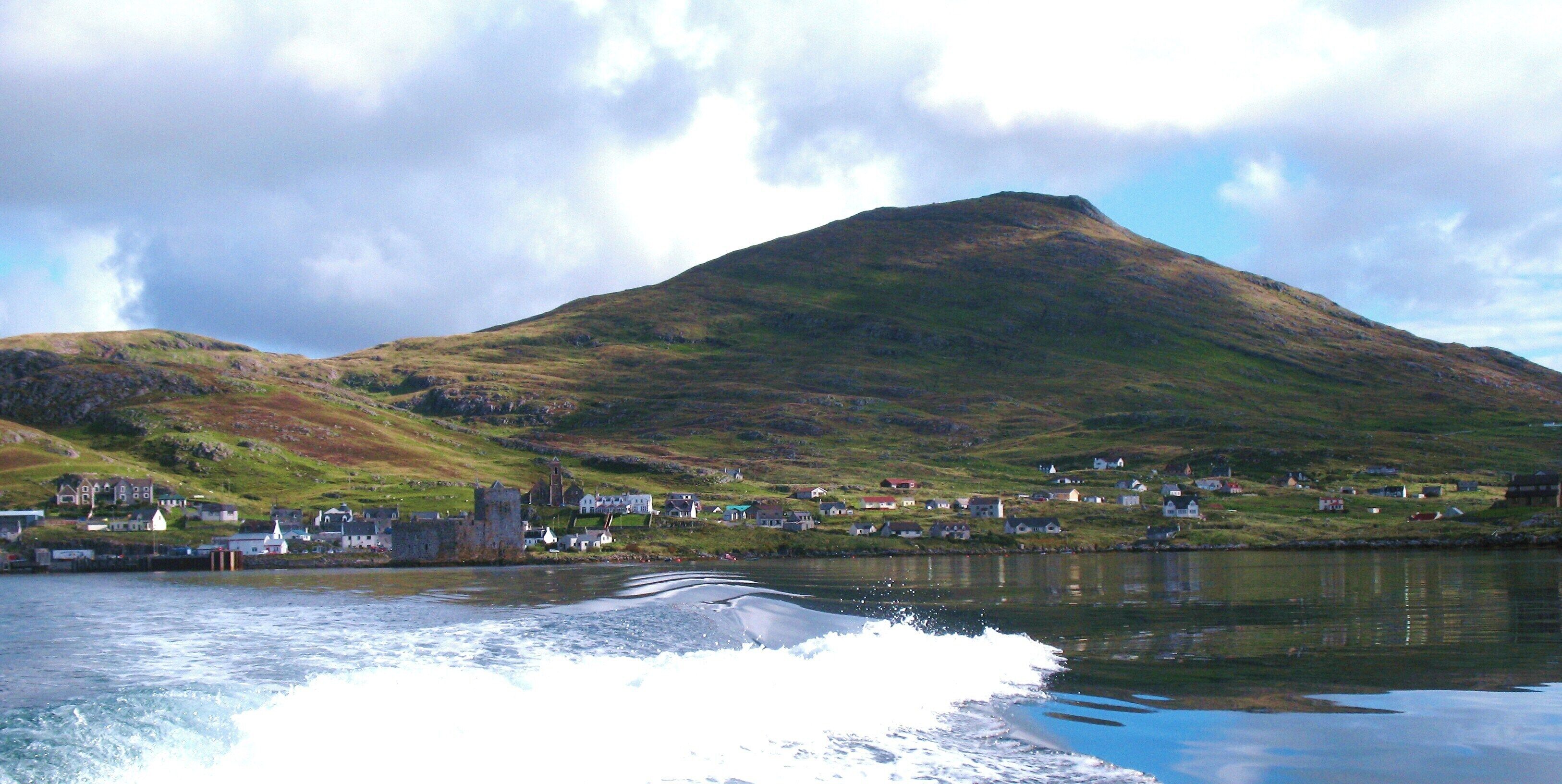 Heading out into the bay. Looking back to Kisimul Castle, the village of Castlebay and the peak of Heabhal from Donald MacLeod's boat.