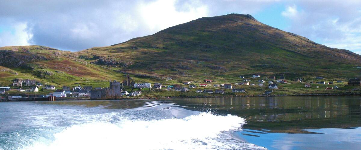 Heading out into the bay. Looking back to Kisimul Castle, the village of Castlebay and the peak of Heabhal from Donald MacLeod's boat.