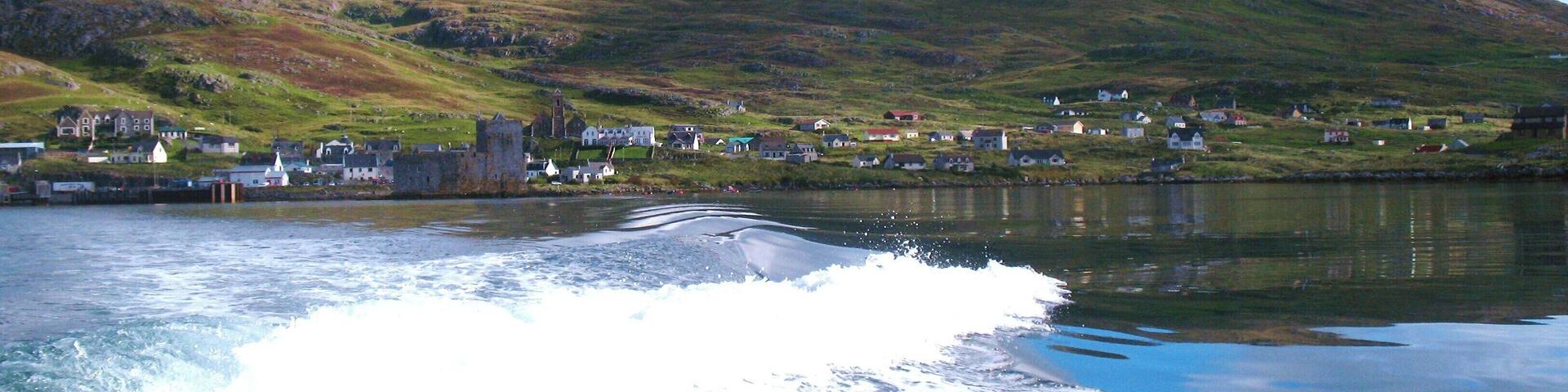 Heading out into the bay. Looking back to Kisimul Castle, the village of Castlebay and the peak of Heabhal from Donald MacLeod's boat.