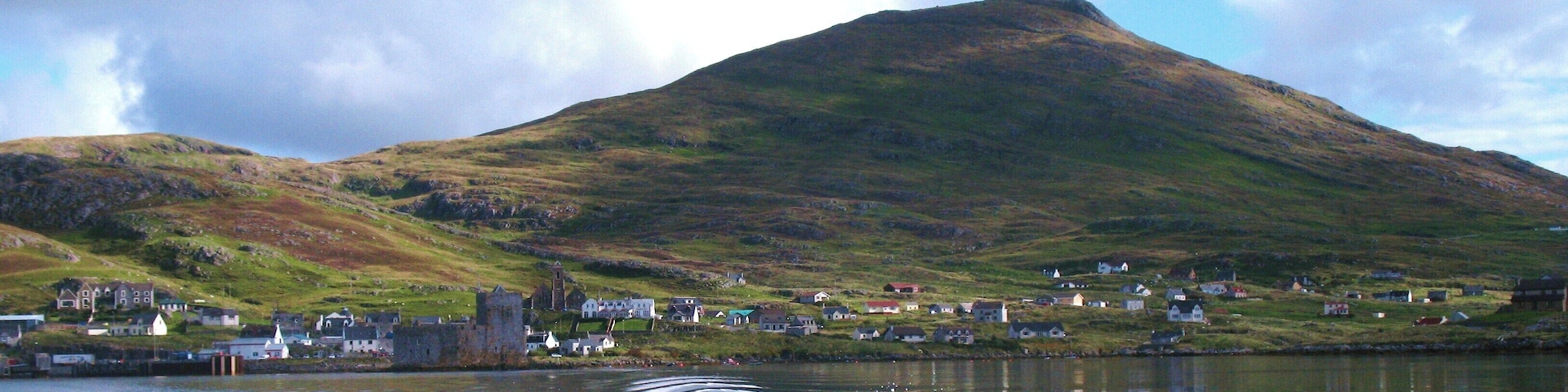 Heading out into the bay. Looking back to Kisimul Castle, the village of Castlebay and the peak of Heabhal from Donald MacLeod's boat.