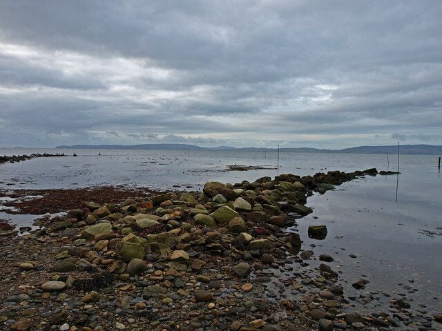 Shore at Blackwaterfoot, Arran The rocky shore near the small harbour entrance. Kintyre in the distance.