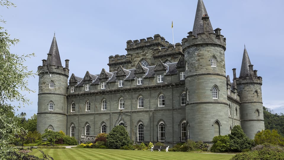 A large castle with multiple towers and arched windows.