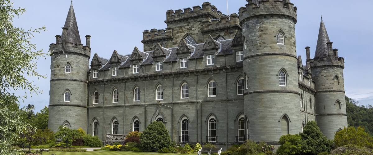 A large castle with multiple towers and arched windows.