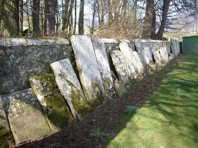 A 'ro'up' of old grave slabs Rescued and stacked against the cemetery wall.