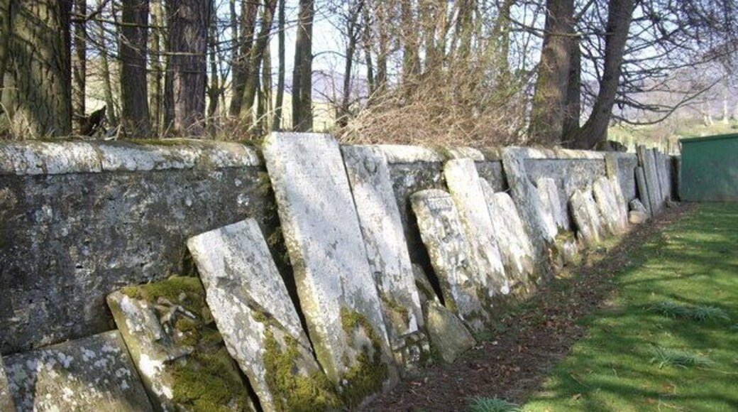 A 'ro'up' of old grave slabs Rescued and stacked against the cemetery wall.