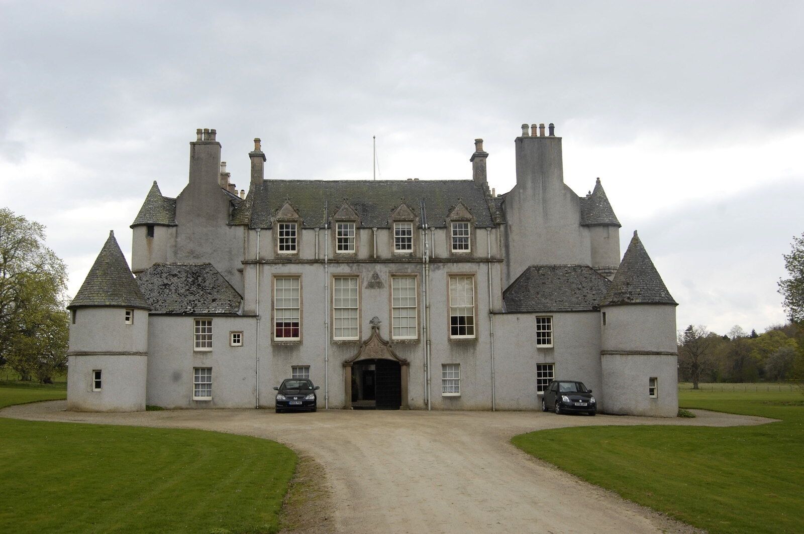 A large, historic building with multiple towers and a central entrance.