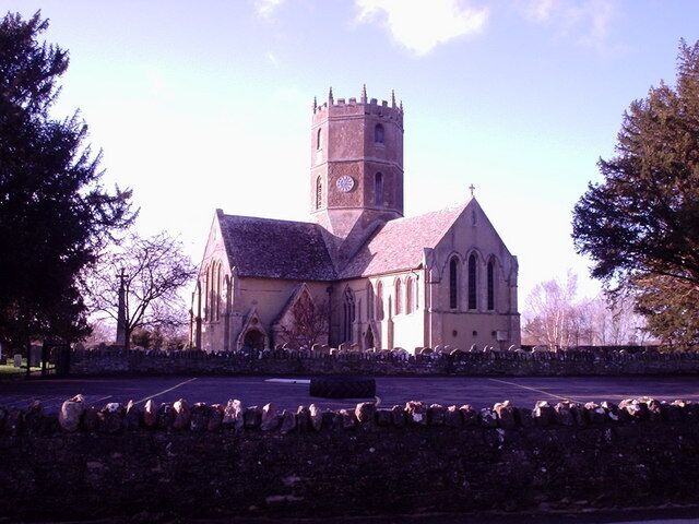 A church with a tall tower and a smaller building in front.