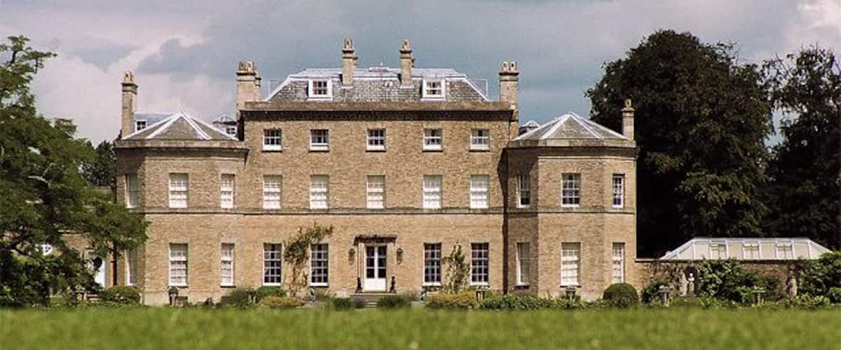 A large, historic building with multiple chimneys and a prominent entrance.