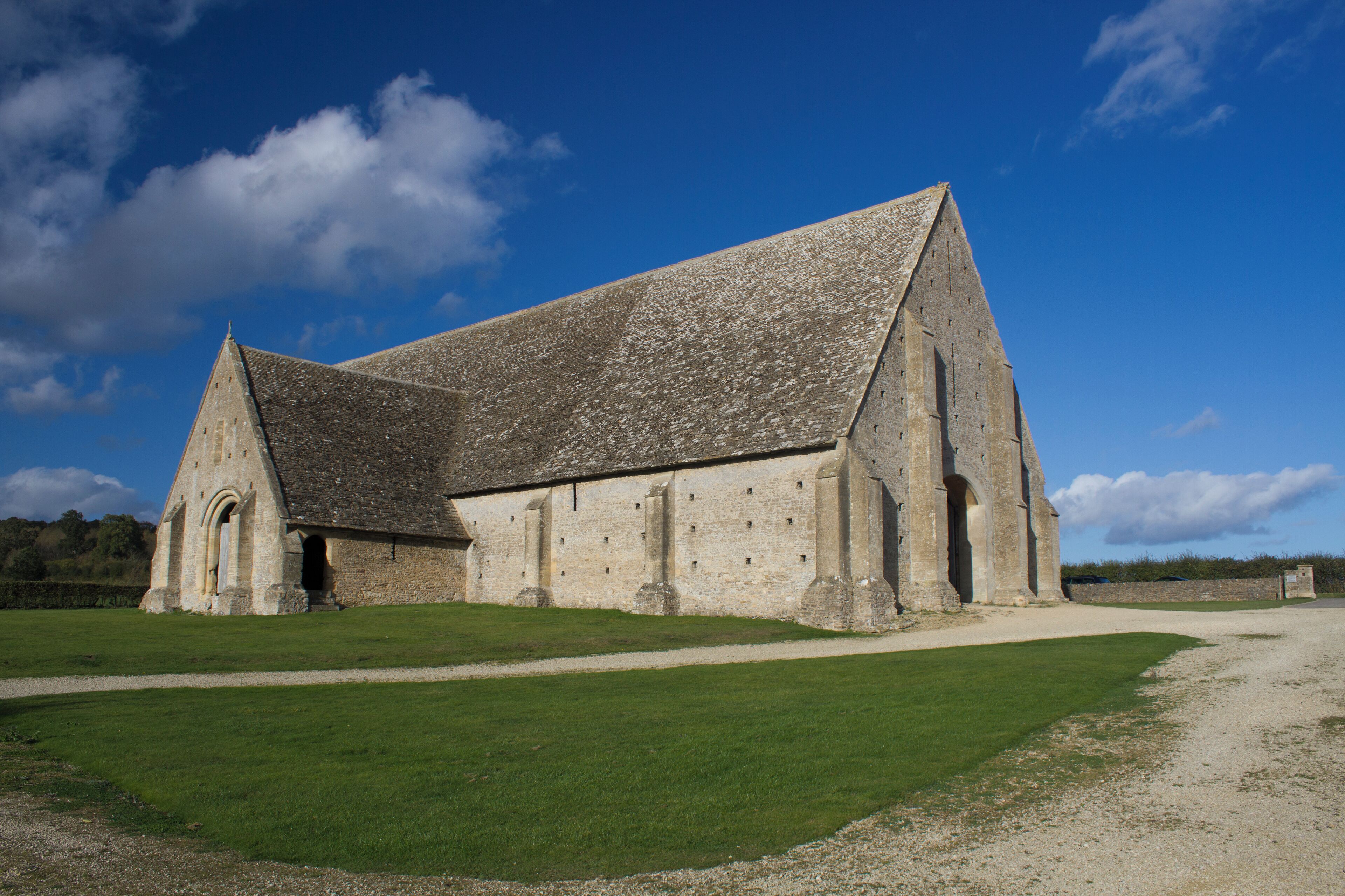 A large stone church with a steep roof and a small bell tower.