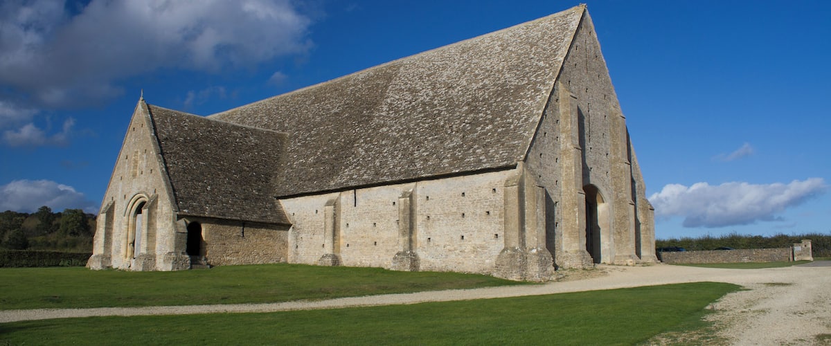 A large stone church with a steep roof and a small bell tower.