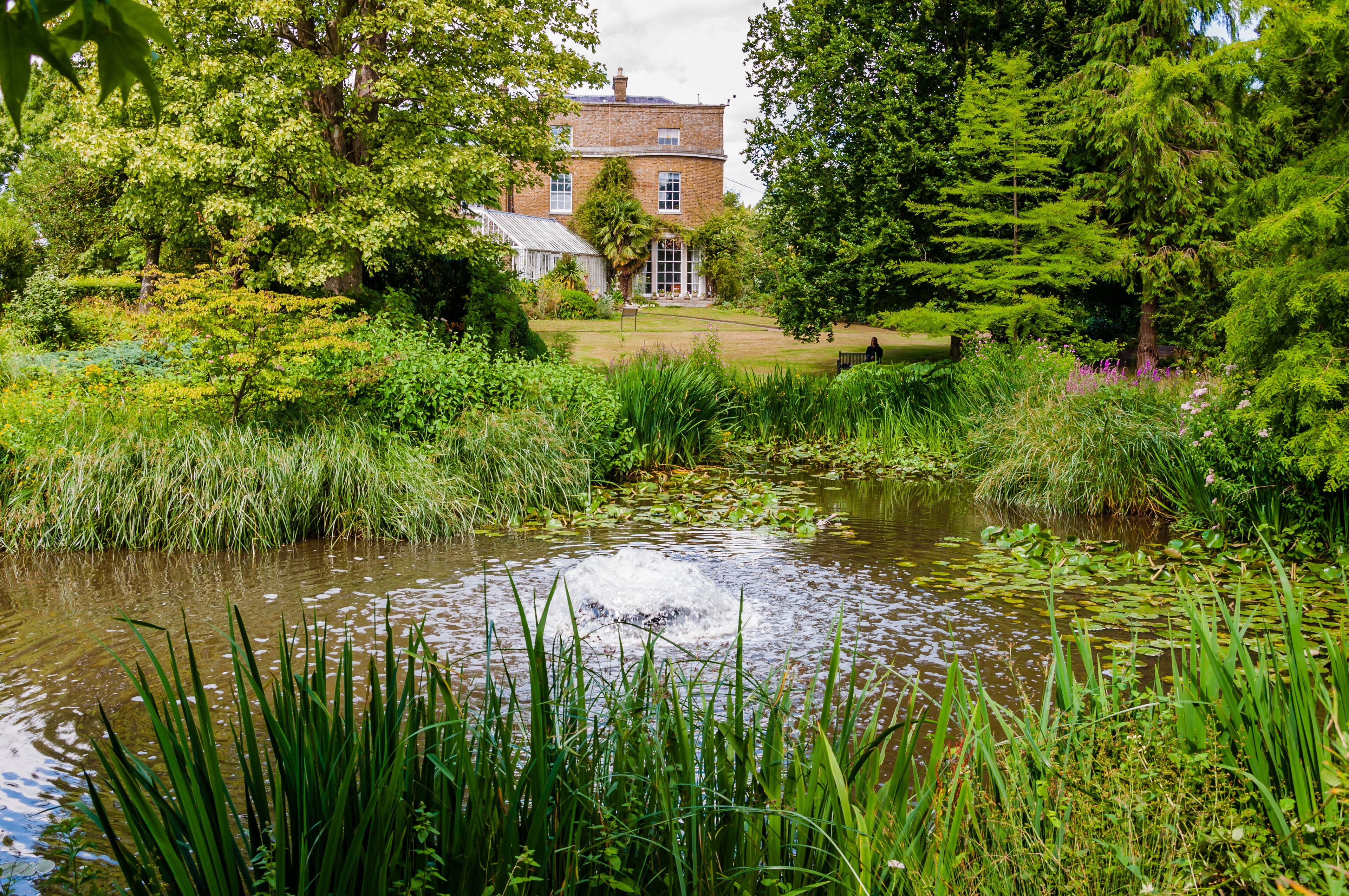 London, UK - July 20, 2019:The Hall from the carp pond atMyddelton House Gardens, Bulls Cross, Enfield, London, England, EN2 