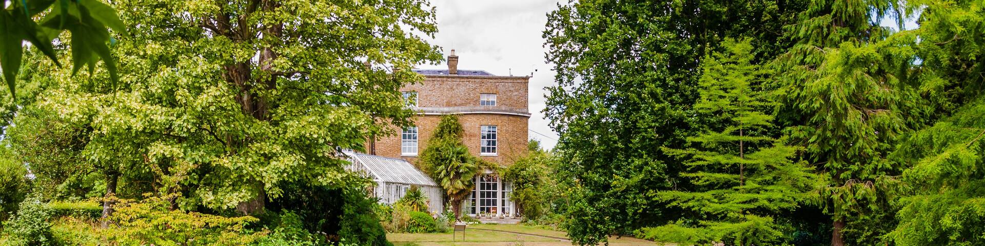 London, UK - July 20, 2019:The Hall from the carp pond atMyddelton House Gardens, Bulls Cross, Enfield, London, England, EN2