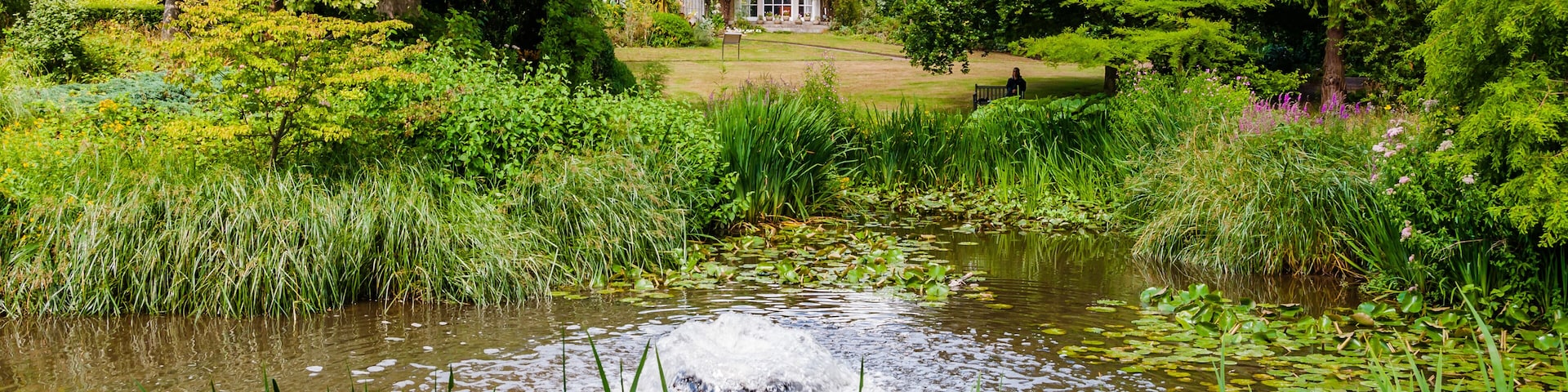 London, UK - July 20, 2019:The Hall from the carp pond atMyddelton House Gardens, Bulls Cross, Enfield, London, England, EN2