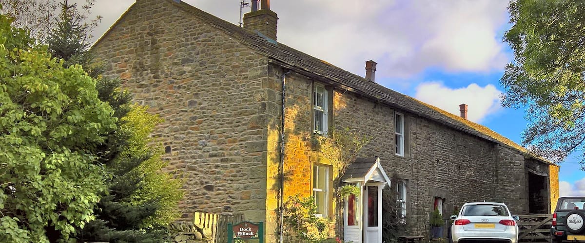 A stone building with a sign reading "Dock Hillock."