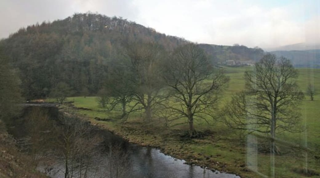 New Laund Hill, Whitewell, Lancashire. Looking west across the River Hodder, which runs alongside the Inn at Whitewell, towards New Laund Hill. This hill rises steeply to 229 metres above sea level. The buildings in the middle distance are the tiny hamlet of New Laund, just in the next square north. Apologies for the reflections in the window . . . the photograph was taken from the west end of the dining room in the Inn 92217.