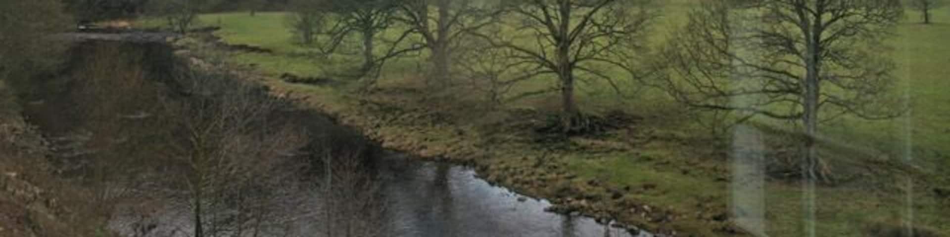 New Laund Hill, Whitewell, Lancashire. Looking west across the River Hodder, which runs alongside the Inn at Whitewell, towards New Laund Hill. This hill rises steeply to 229 metres above sea level. The buildings in the middle distance are the tiny hamlet of New Laund, just in the next square north. Apologies for the reflections in the window . . . the photograph was taken from the west end of the dining room in the Inn 92217.