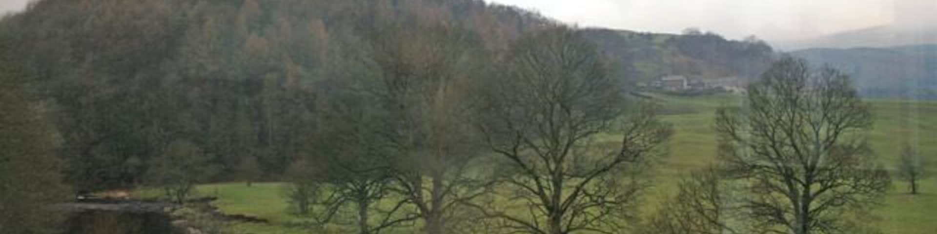 New Laund Hill, Whitewell, Lancashire. Looking west across the River Hodder, which runs alongside the Inn at Whitewell, towards New Laund Hill. This hill rises steeply to 229 metres above sea level. The buildings in the middle distance are the tiny hamlet of New Laund, just in the next square north. Apologies for the reflections in the window . . . the photograph was taken from the west end of the dining room in the Inn 92217.