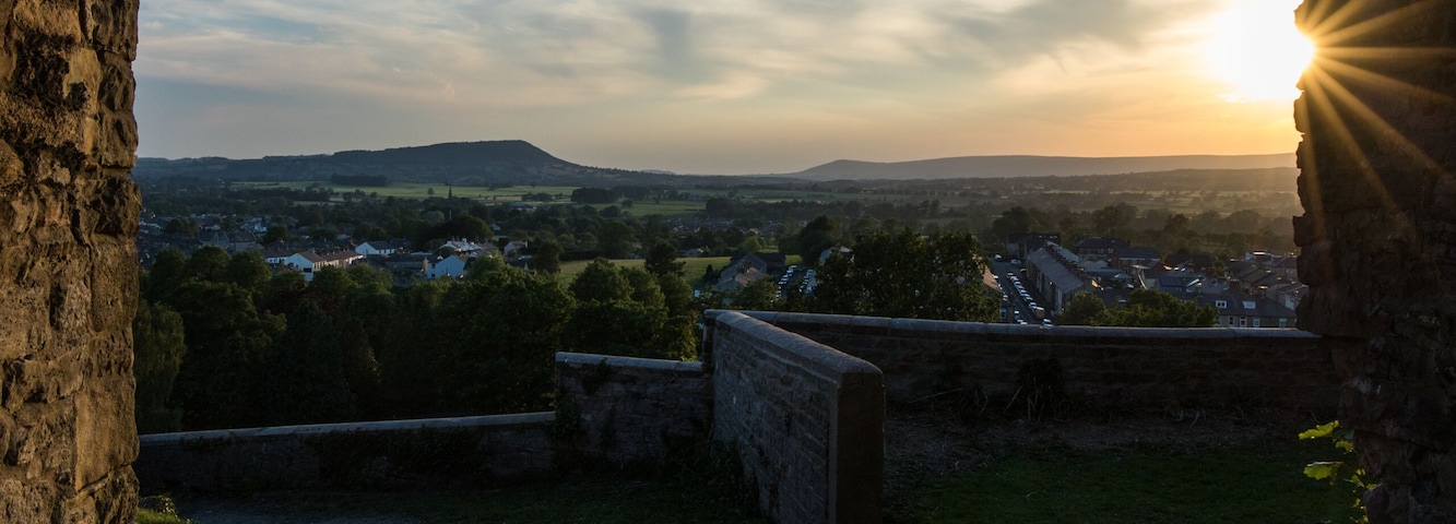 Viewpoint from Clitheroe castle looking through an arch into the Ribble valley. Sunset over Longridge fell