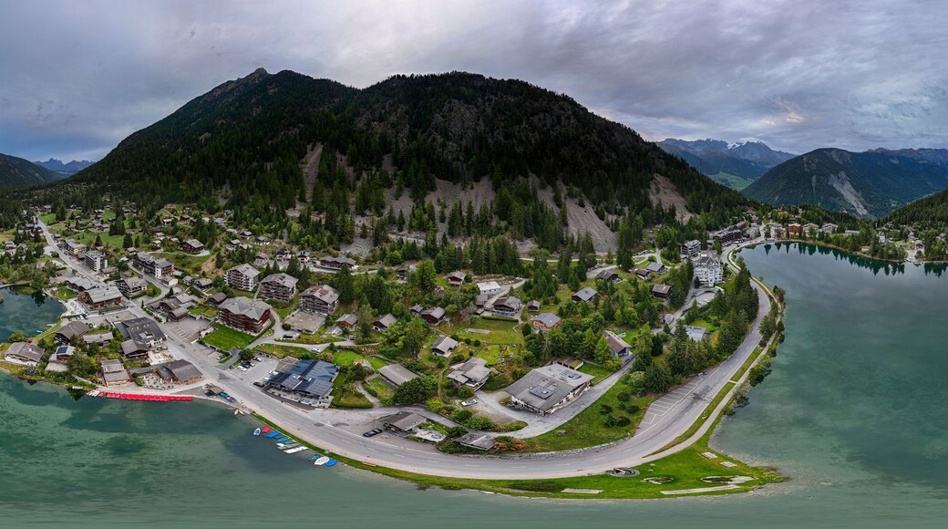 High resolution extreme color aerial panorama take with drone of the famous Swiss town of Champex Lac with its peaceful lake and alp mountains surrounding it part of the famous TMB- Tour du Mont Blan