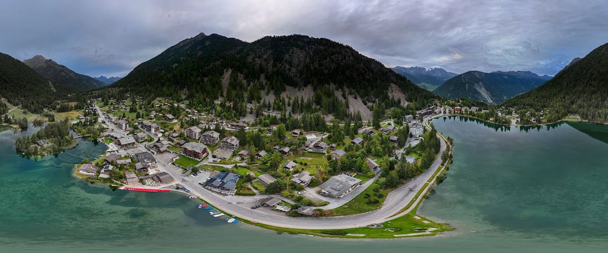 A lakeside village with houses and a road.