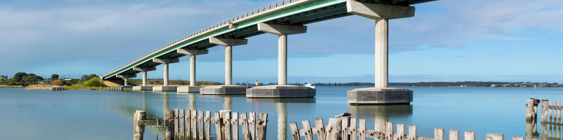 J0427B Reflected fence pylons and the bridge between Goolwa and Hindmarsh Island, South Australia. Part of the Fleurieu Peninsula.